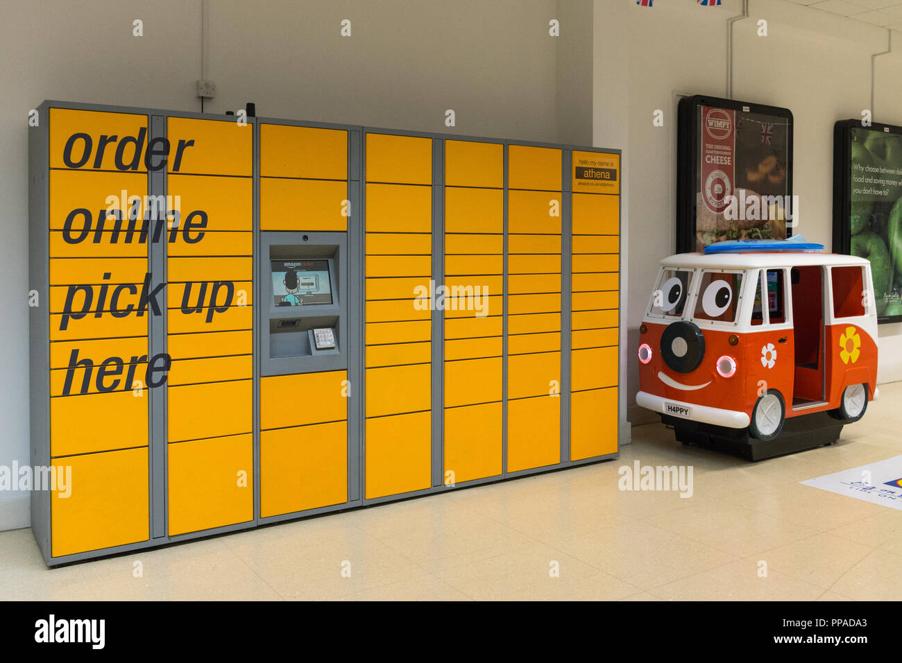 Yellow Amazon lockers and pick up point for packages ordered online in an indoor shopping centre, UK Stock Photo