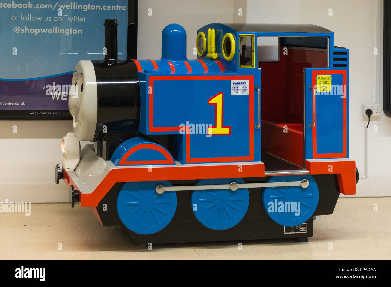 Child's coin operated Thomas the Tank Engine ride in an indoor shopping centre, UK Stock Photo