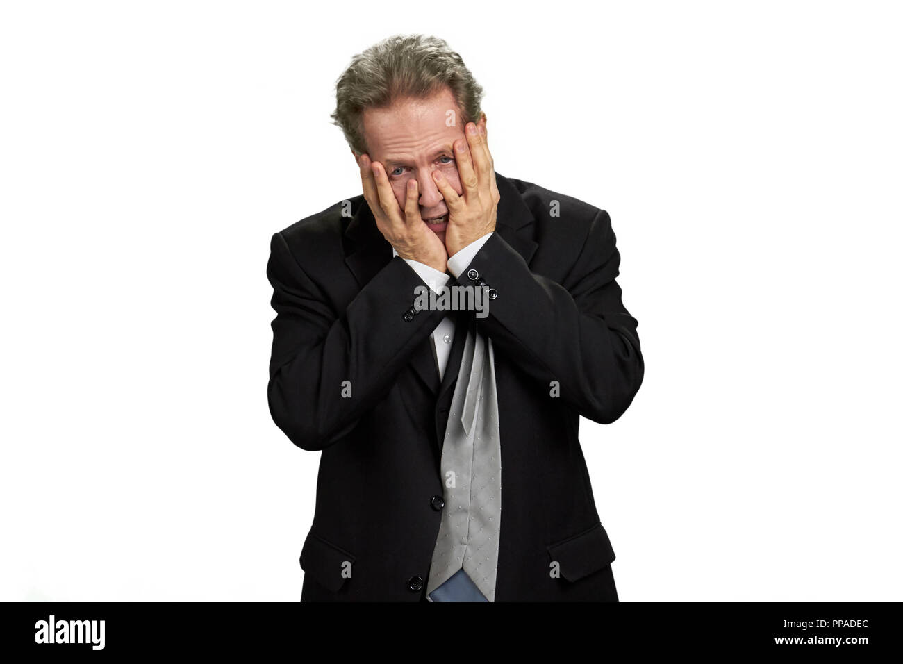 Depressed man covering his face by hands Stock Photo - Alamy