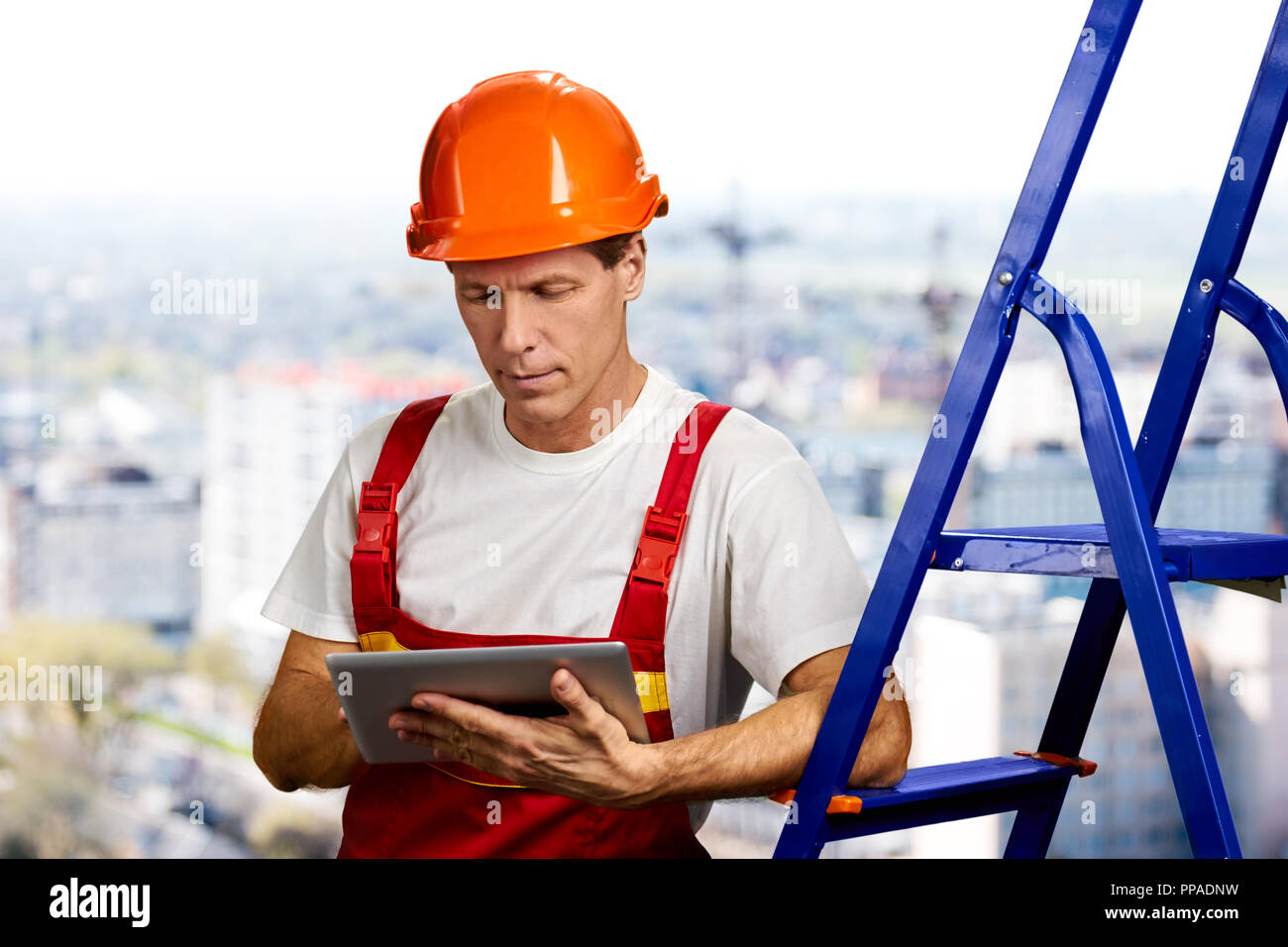 Confident foreman working on digital tablet. Stock Photo