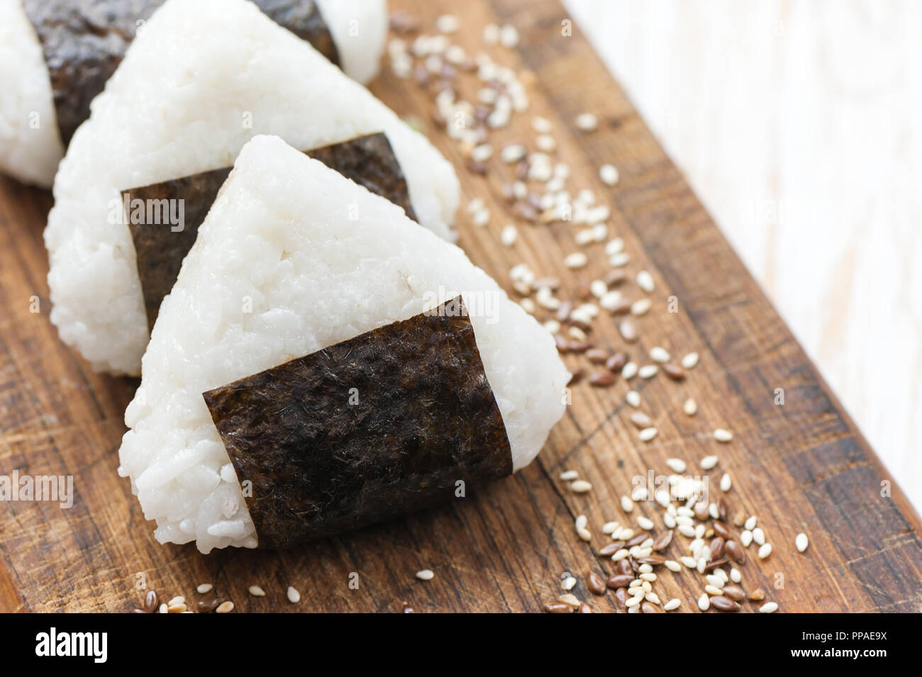 Onigiri. Rice triangle with nori seaweed on white plate Stock Photo - Alamy