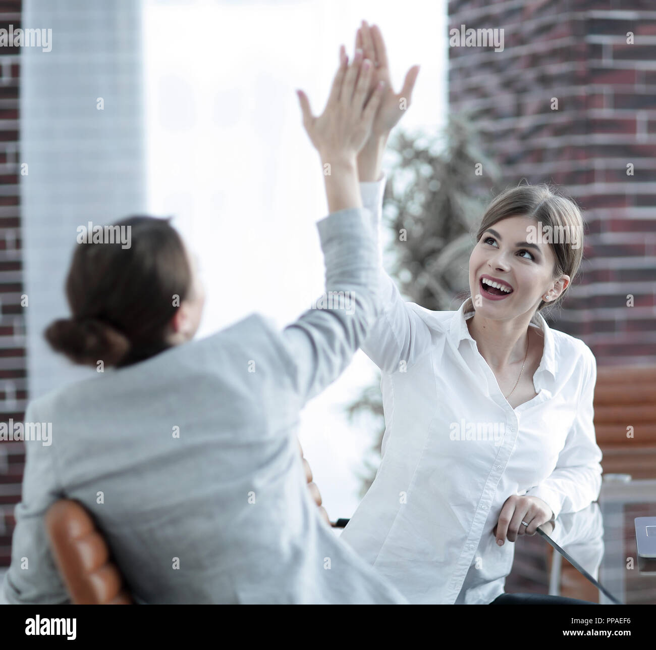 members of the business team giving each other a high five Stock Photo ...