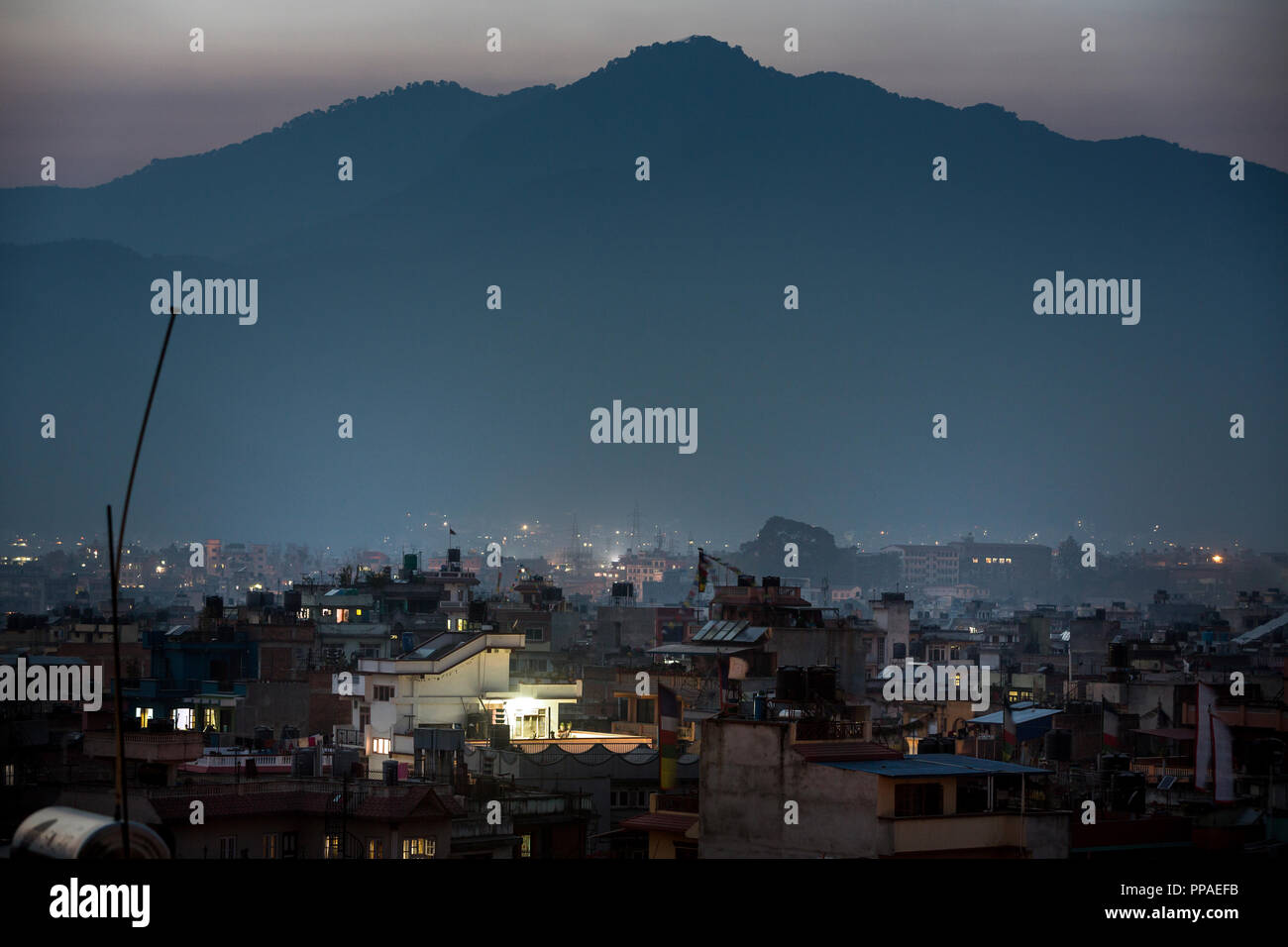 Dusk over Nepal's capital Kathmandu with Himalaya Mountains in background. Stock Photo