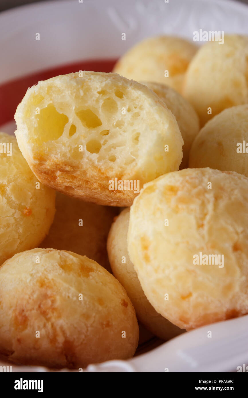 Close-up of a bitten homemade Brazilian cheese bread (also known as pão de queijo) in the basket. Selective focus. Stock Photo