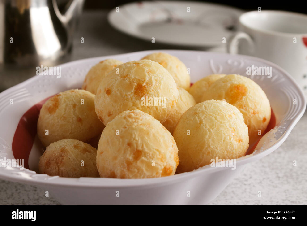 A simple Brazilian breakfast setting, with coffee and cheese bread (also known as pão de queijo), a common combination in Brazil. Stock Photo