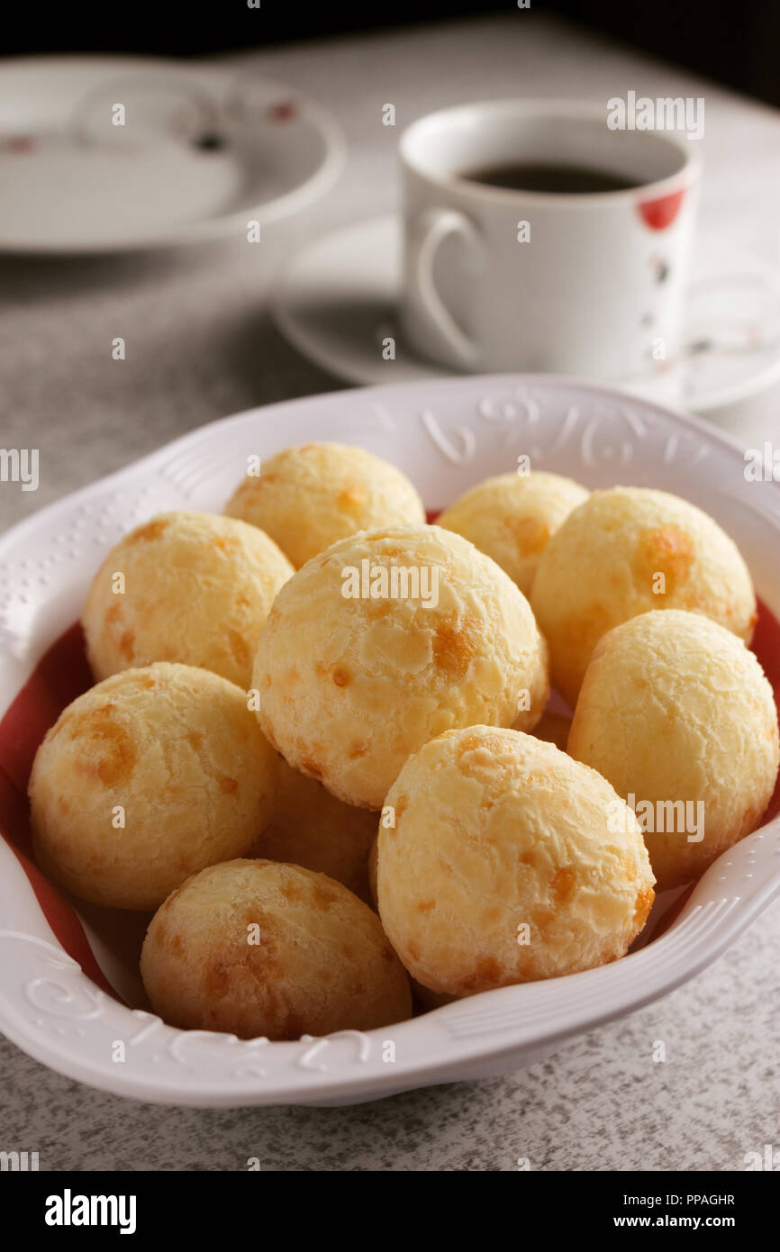 A simple Brazilian breakfast setting, with coffee and cheese bread (also known as pão de queijo); copy space for text, selective focus. Stock Photo