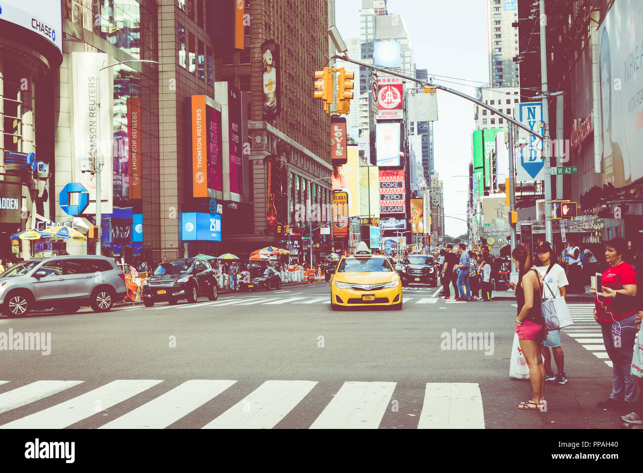 NEW YORK - SEPTEMBER 2, 2018: New York City street road in Manhattan at summer time, many cars, yellow taxis and busy people walk to work. Stock Photo