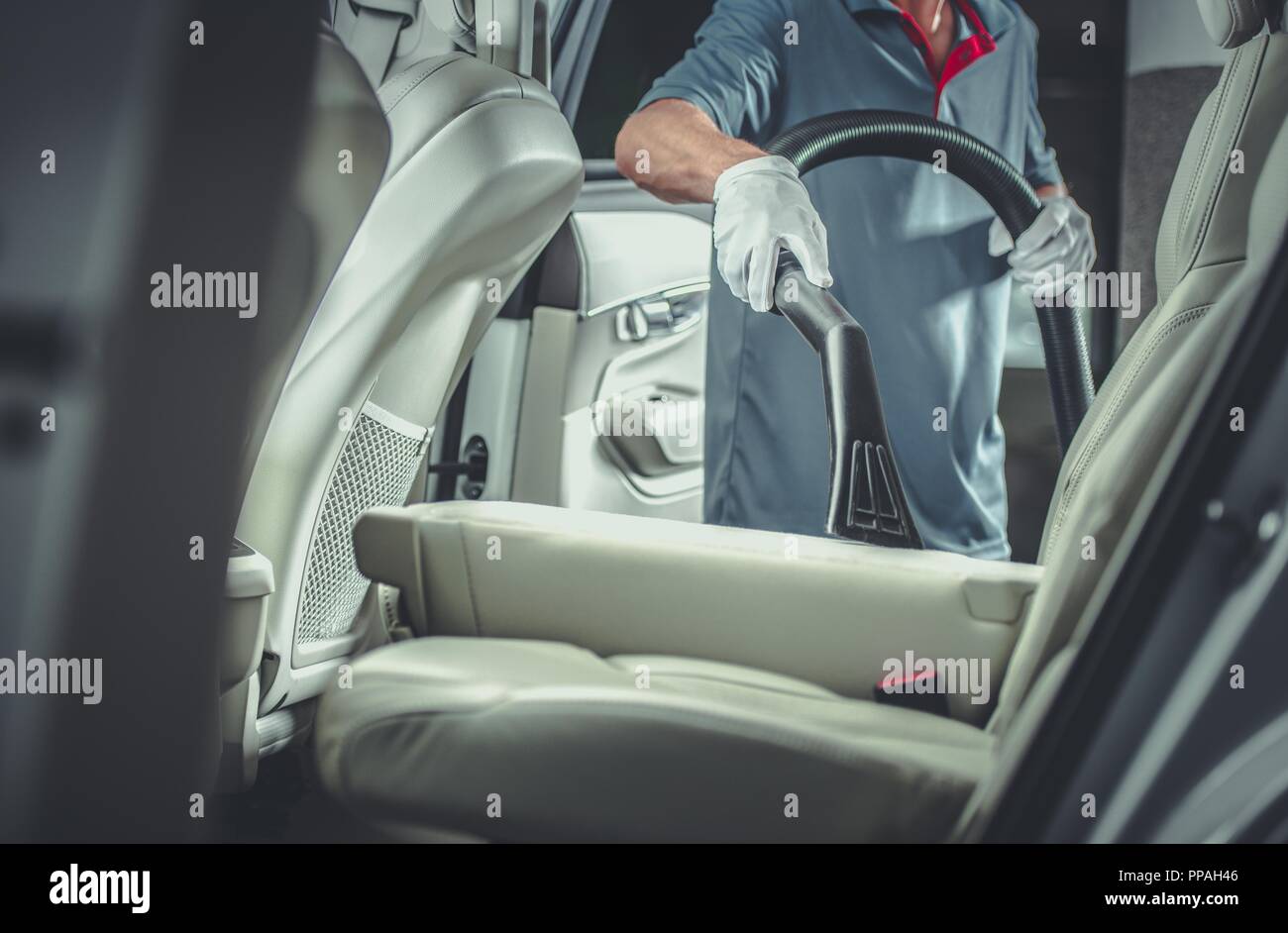 Professional Car Vacuuming in the Vehicles Cleaning and Detailing Service. Automotive Theme. Stock Photo