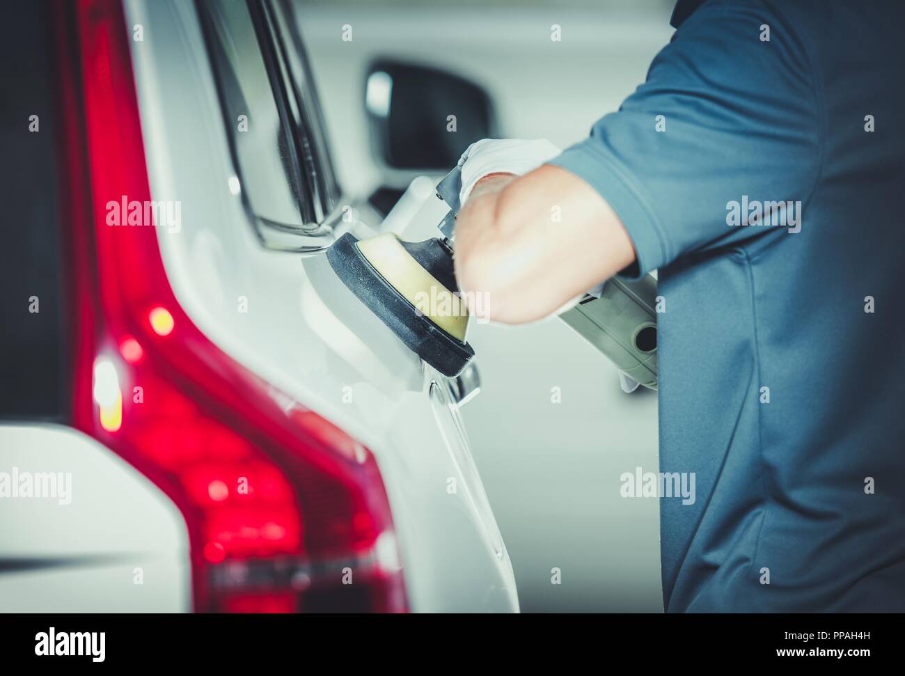 Professional Vehicle Buffing by Caucasian Car Detailing Service Worker. Removing Scratches From the Car Body Paint. Auto Polishing. Stock Photo