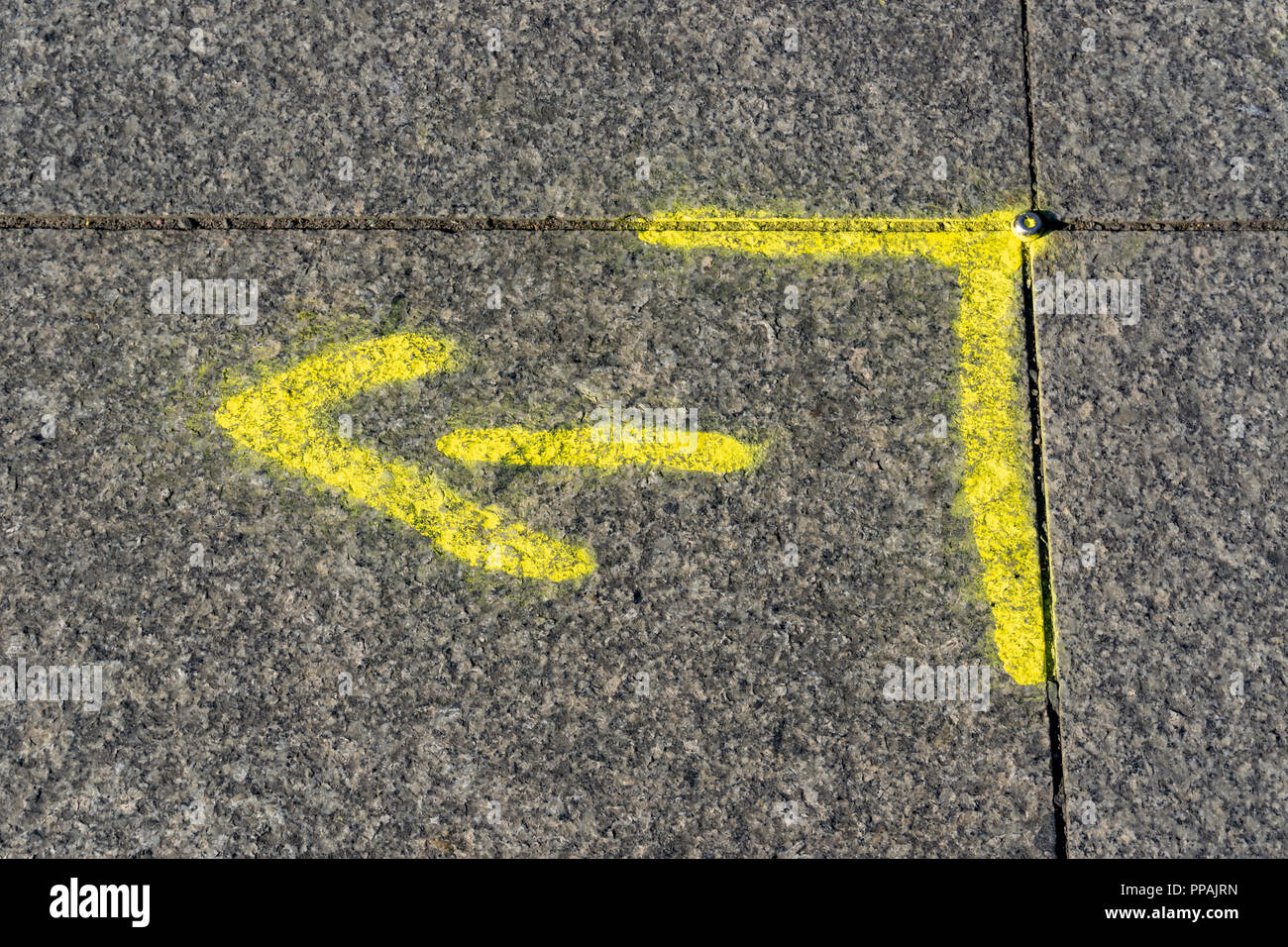 Berlin, Germany, September 18, 2018: Close-Up of Yellow Arrow Road Marking Stock Photo