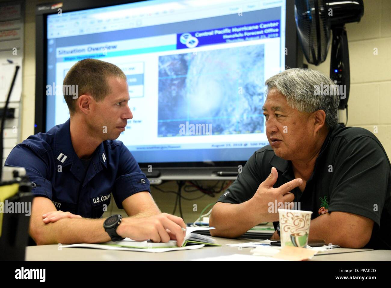 Coast Guard Marine Safety Team Supervisor Lt. John Botti meets with