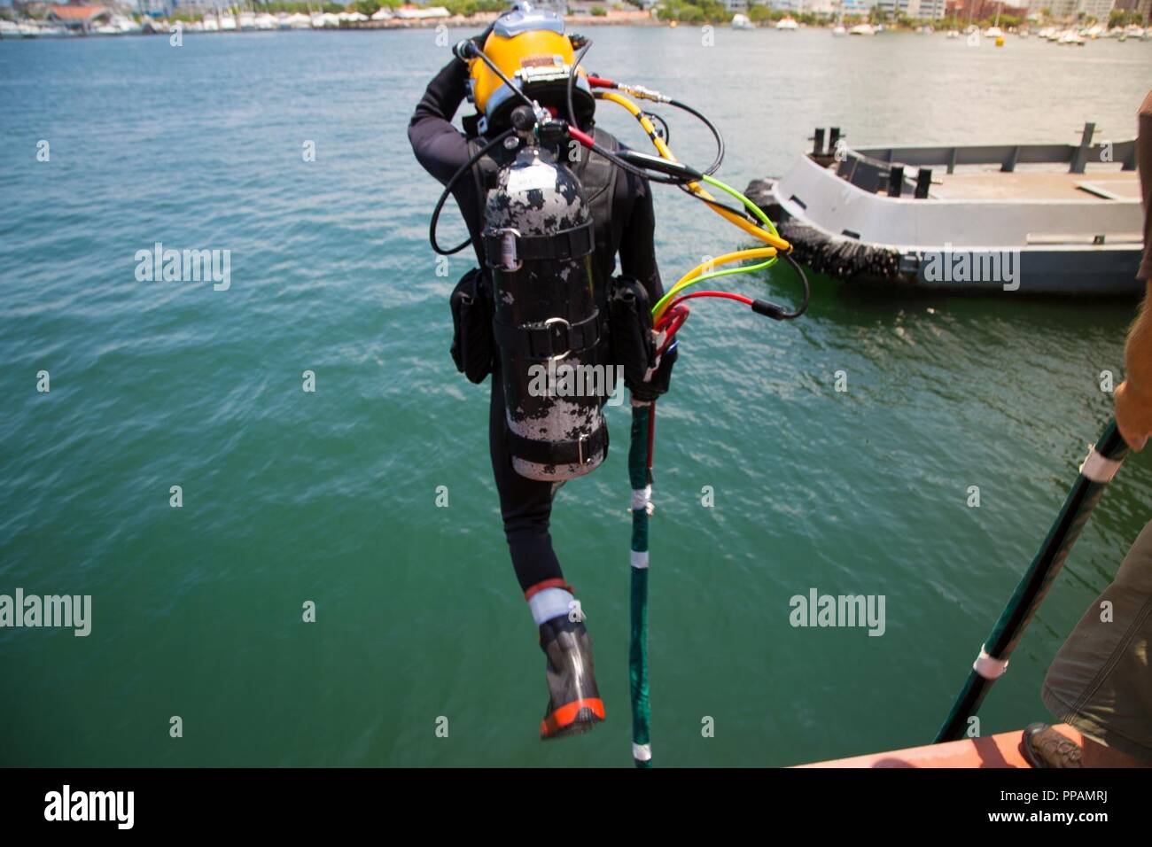 A Colombian Navy diver conducts a front step water entry in Cartagena ...