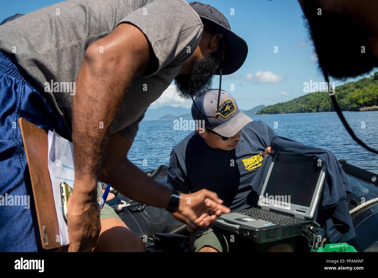 U.S. Navy Diver 1st Class Jonathan Miranda, assigned to Mobile Diving and  Salvage Unit (MDSU) 2, demonstrates to a Trinidad and Tobago Coast Guard  dive team member how to employ side scan