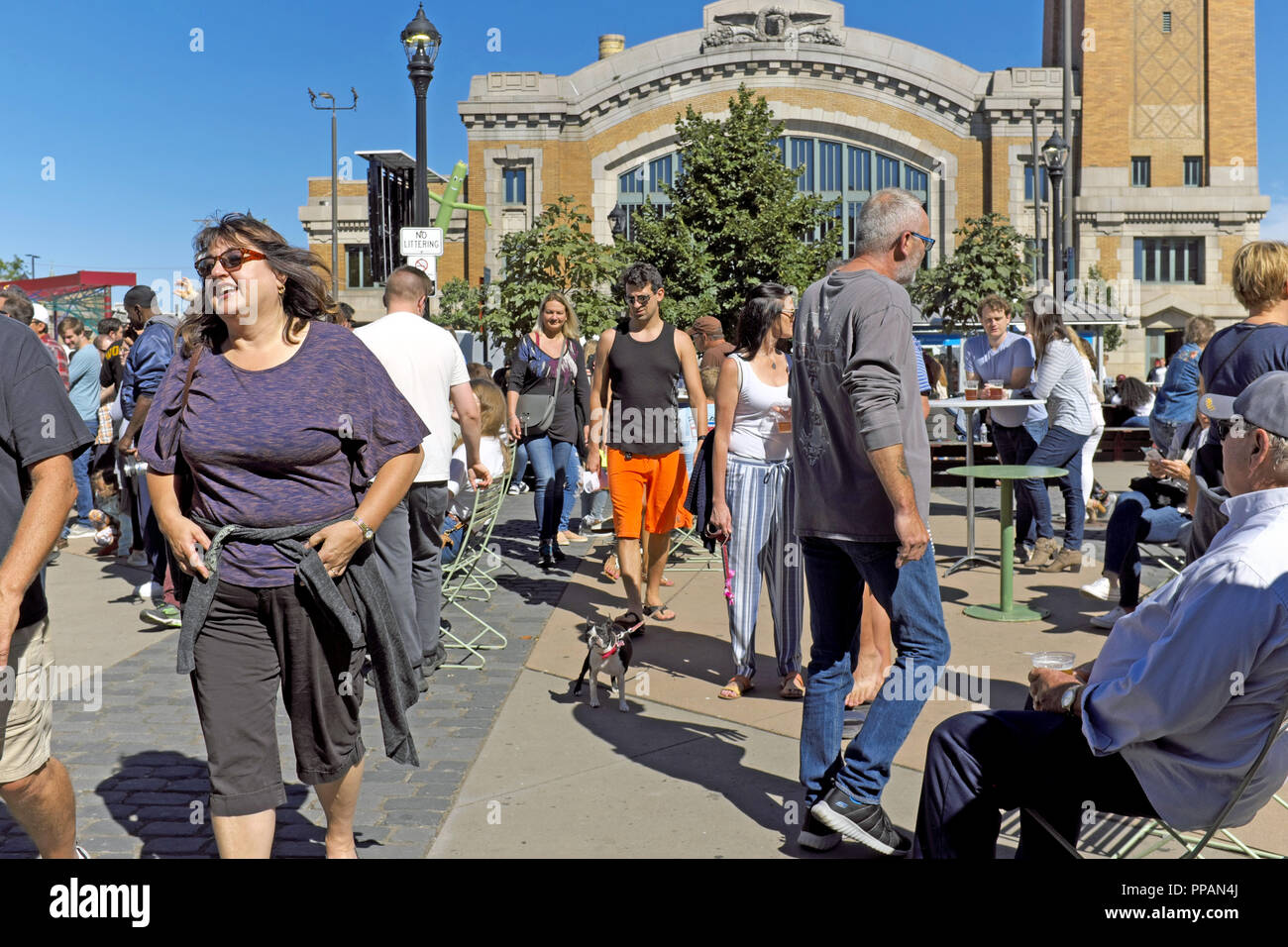Clevelanders enjoy early fall sunshine in Market Square across from the West Side Market during the annual Ohio City Street Fair. Stock Photo
