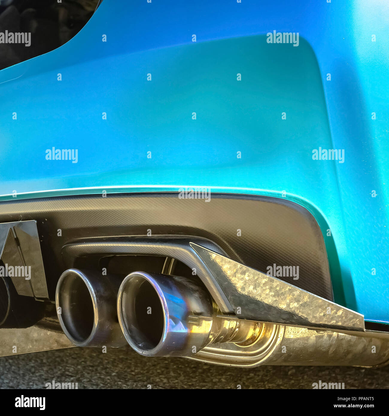 Metallic blue car with dual exhaust pipe Stock Photo Alamy
