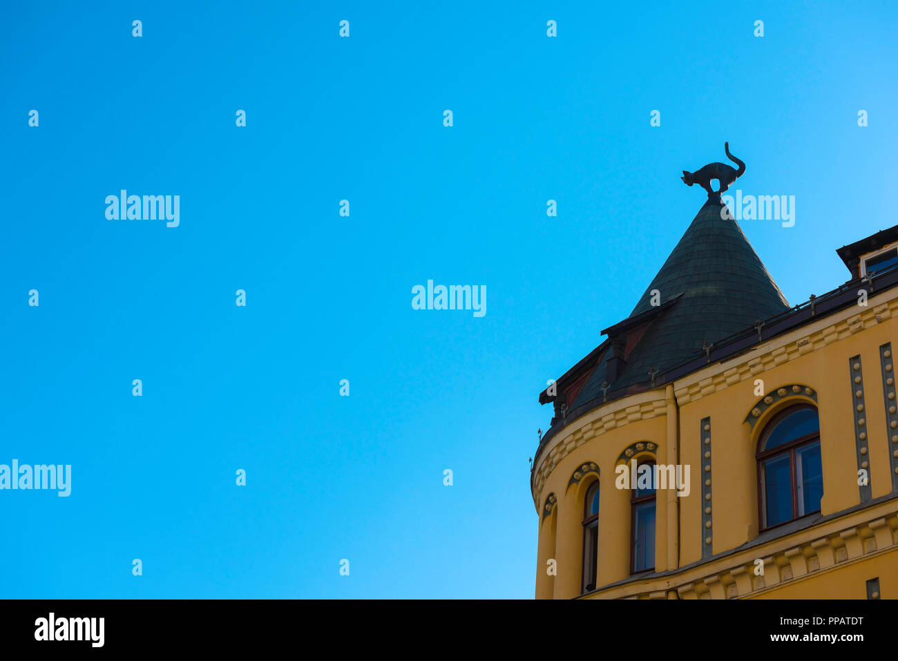 Riga Cat House, view of a cat in silhouette sited on a corner turret of the famous Cat House (Kaku Nams) in Old Riga, Latvia. Stock Photo