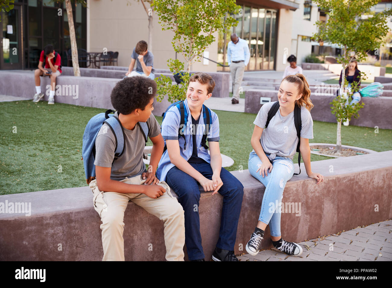 Group Of High School Students Hanging Out During Recess Stock Photo