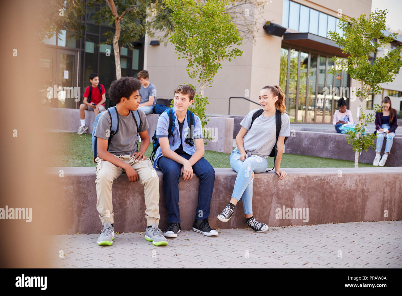 Group Of High School Students Hanging Out During Recess Stock Photo