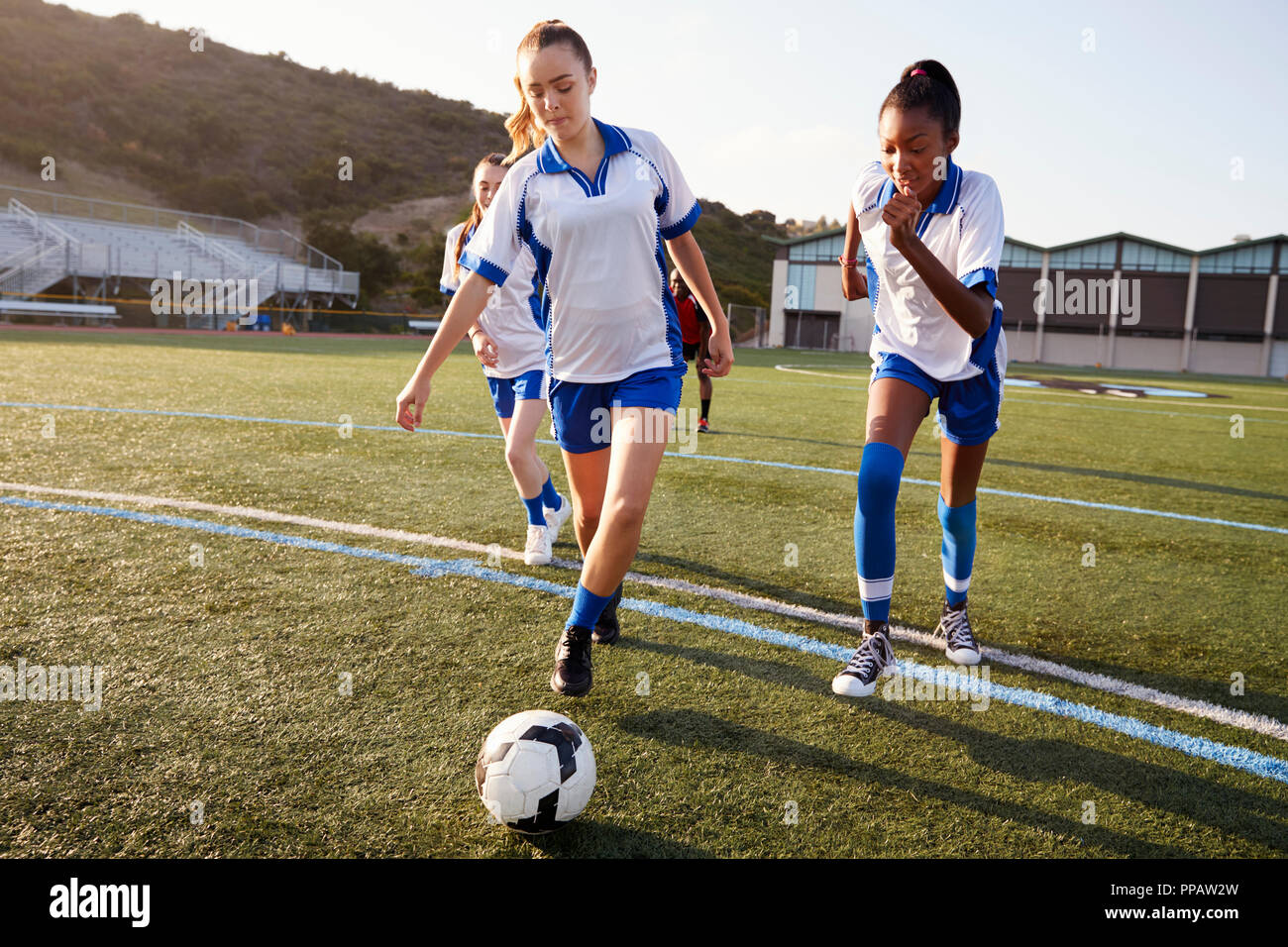 Group Of Female High School Students Playing In Soccer Team Stock Photo