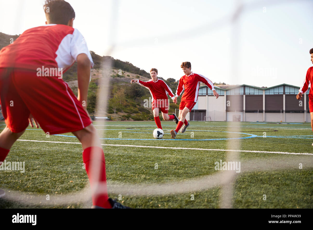 Group Of Male High School Students Playing In Soccer Team Stock Photo