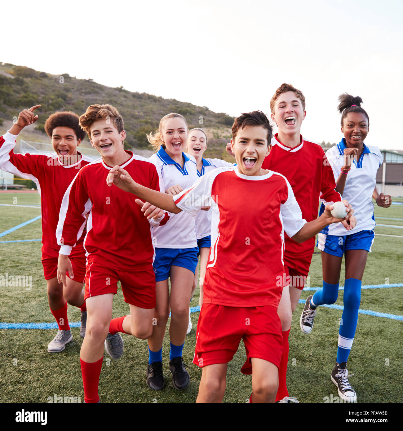 Portrait Of Male And Female High School Soccer Teams Celebrating Stock Photo