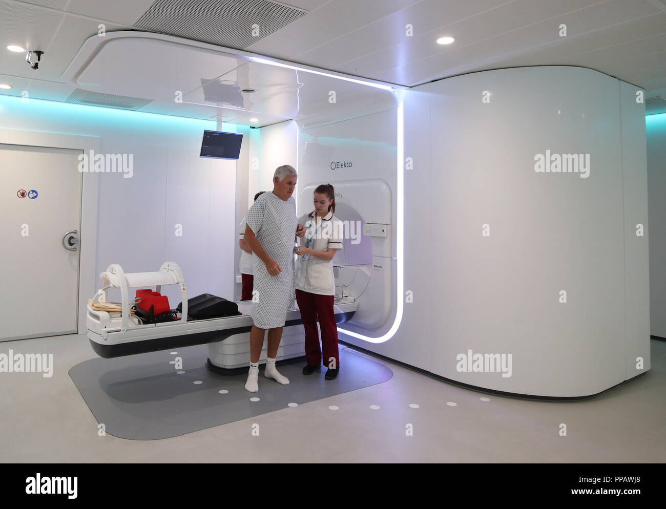 Embargoed to 1700 Monday September 24 Radiographer Gillian Smith helps patient Barry Dolling, aged 65, from Selsdon, Surrey, after treatment using a Magnetic Resonance Linear Accelerator (MR Linac) machine, at the Royal Marsden Hospital in Sutton Surrey. Dolling was diagnosed with prostate cancer in April 2018, and became the first patient in the UK to receive a pioneering new form of radiotherapy. Stock Photo
