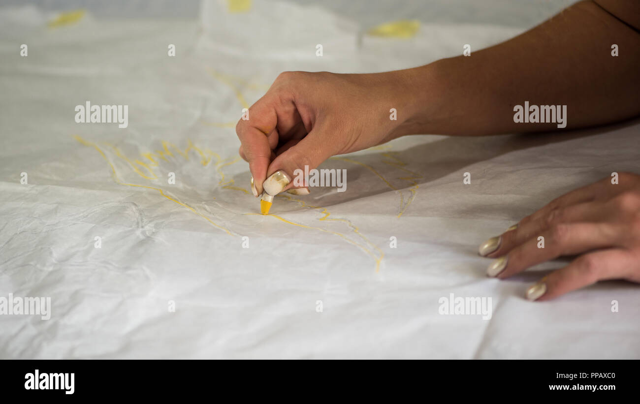 the artist draws a sketch through tracing paper, close-up Stock Photo