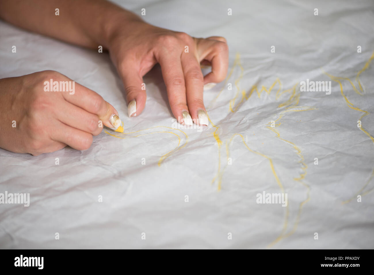 the artist draws a sketch through tracing paper, close-up Stock Photo