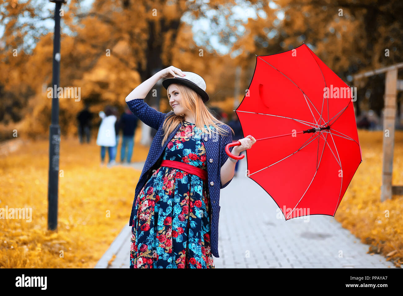Girl in the street with an umbrella Stock Photo - Alamy