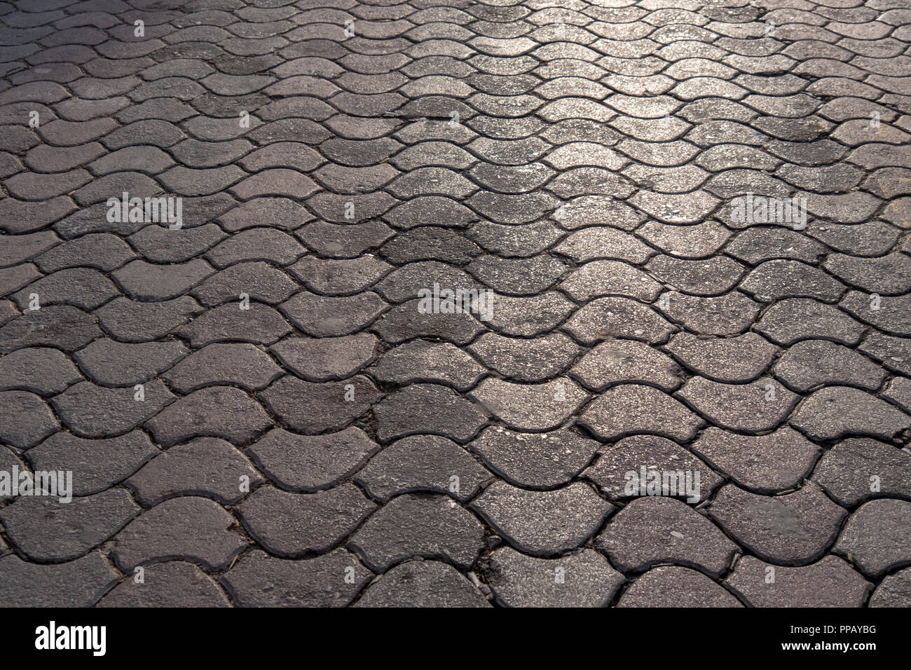 pink and gray cement block on sidewalk, street paving slab, perspective background and texture, fixed tessellated sidewalk tile. Stock Photo