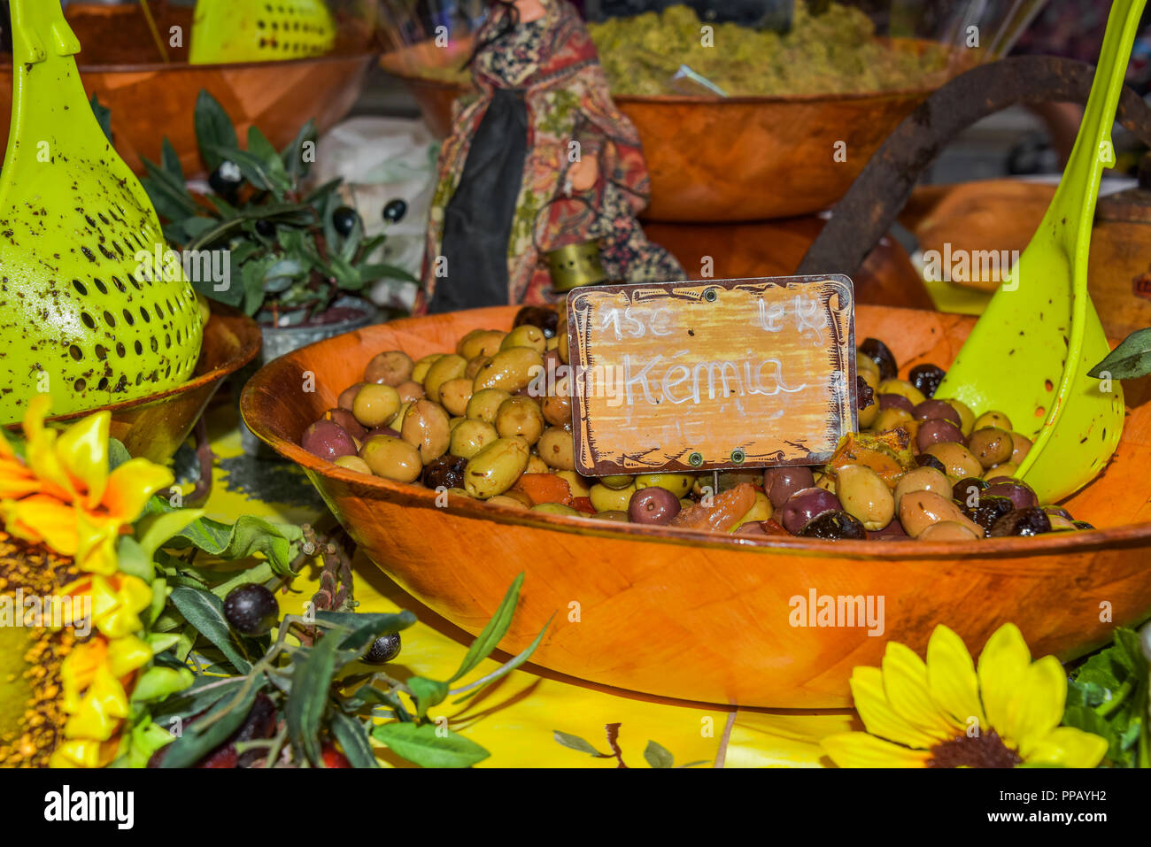 presentation of regional products, olives of the Provence with sunflowers decoration and olive branches, Riez, France, street market Stock Photo