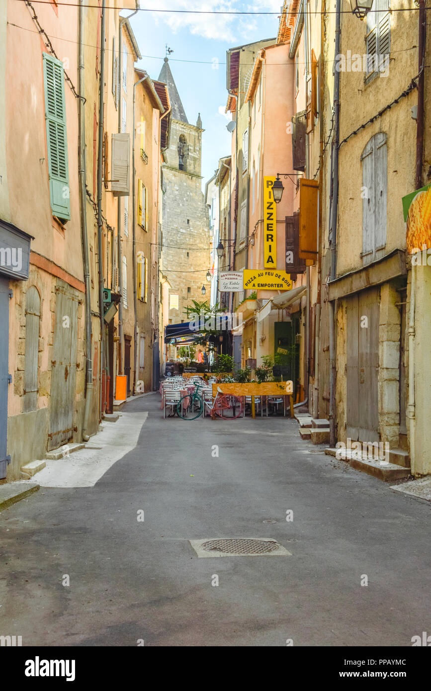 lane with restaurant and colourful houses in the village Riez, Provence, France, department Alpes-de-Haute-Provence, region Provence-Alpes-Côte d’Azur Stock Photo