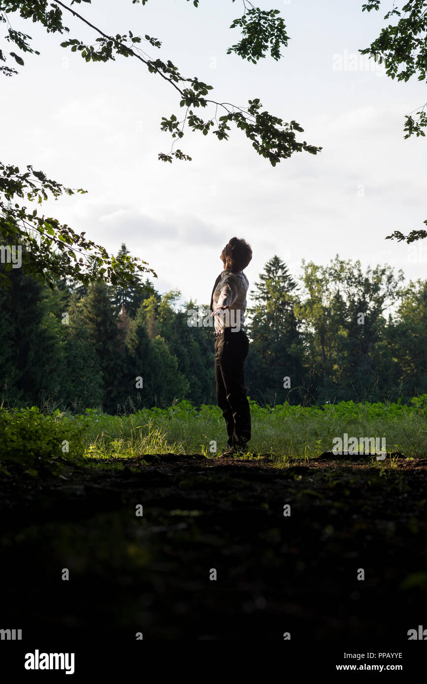 people enjoying nature on Young Man Enjoying Nature Standing With Outstretched Arms Looking Up Into The Sky In A Rural Field Side View Stock Photo Alamy