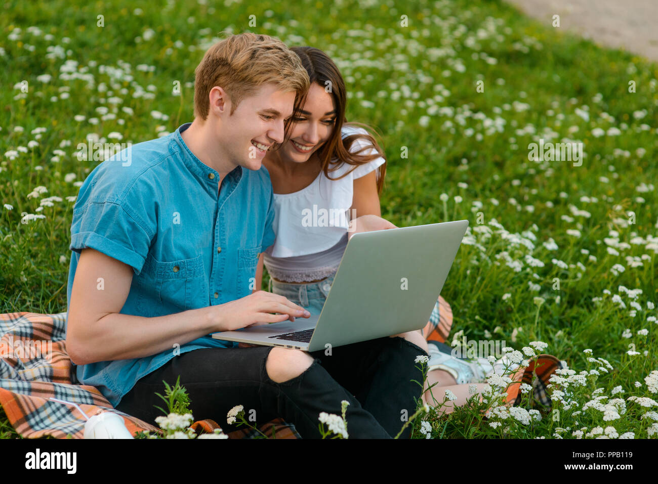 Couple uses the Internet outdoors Stock Photo - Alamy