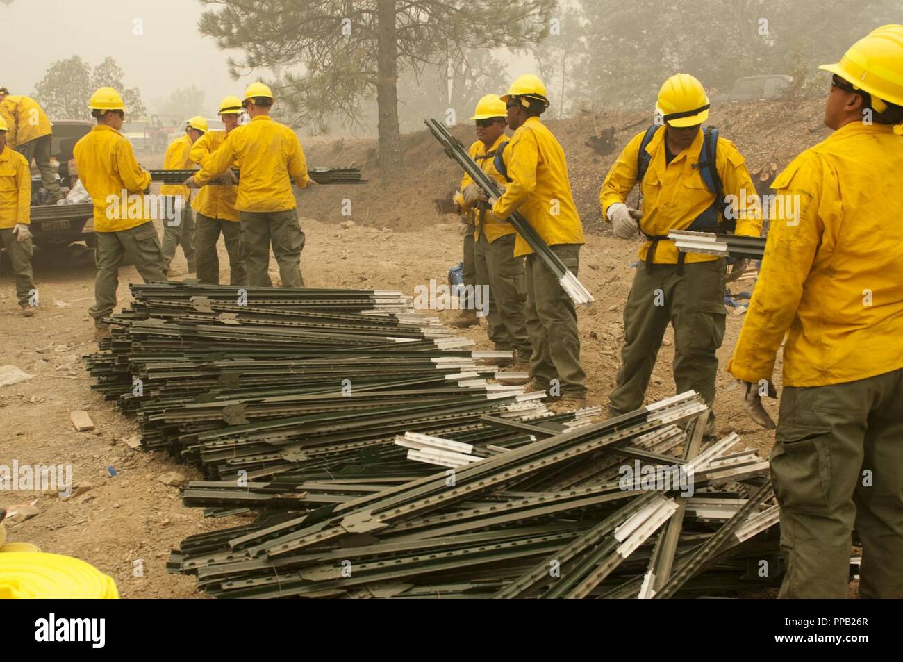 Task Force Rugged Soldiers assigned to 14th Brigade Engineer Battalion at Joint Base Lewis-McChord, Washington load fire barrier building materials into a truck, August 13, 2018, in Mendocino National Forest, California. More than 200 active duty Soldiers from JBLM traveled south to the Mendocino Complex Fire to support National Interagency Fire Center wildland fire fighting efforts. Stock Photo