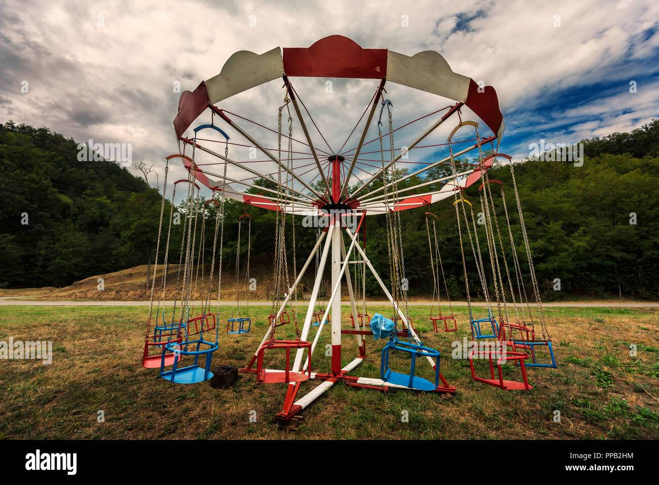 Old abandoned Carousel with Chairs. Merrygoround in the Countryside
