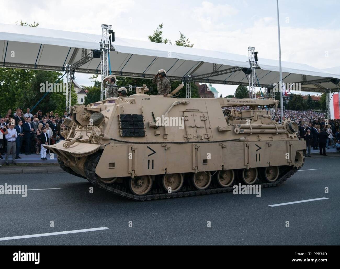 U.S. Soldiers from 1st Squadron, 7th Cavalry Regiment, 1st Armored Brigade Combat Team (1st ABCT) “Ironhorse,” 1st Cavalry Division drive an M88 Hercules heavy equipment recovery vehicle in the Polish Armed Forces Day Parade in Warsaw, Poland, Aug. 15, 2018. Over 40 Ironhorse brigade Soldiers and numerous vehicles participated in the parade. The 1st ABCT is deployed in support of Atlantic Resolve, an exercise committed to peace, security and stability in Europe. Stock Photo