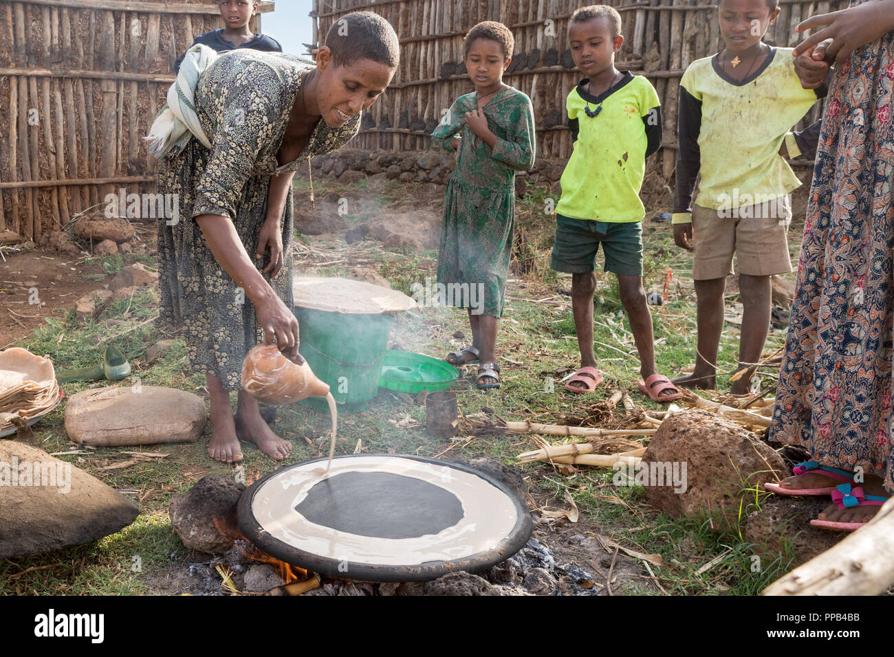 Tigray woman preparing Injera, made from Teff flour & staple to diet, , local villlage to Bahir Dar, Ethiopia, Stock Photo