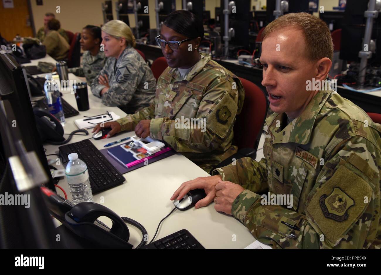U.S. Airmen with the Ninth Air Force J-1 Manpower and Personnel Directorate discuss the Staff Exercise (STAFFEX) 18-5 joint manning document (JMD) for the exercise scenario located in the U.S. Southern Command theater, Aug. 15, 2018, Shaw Air Force Base, S.C. The J-1 directorate not only maintains the JMD but is also the focal point for personnel support actions, as well as manages and synchronizes the level of personnel support provided to the task force during all phases of an operation. STAFFEX 18-5 was the fifth iteration as part of the training plan for Ninth AF to become a Joint Task For Stock Photo