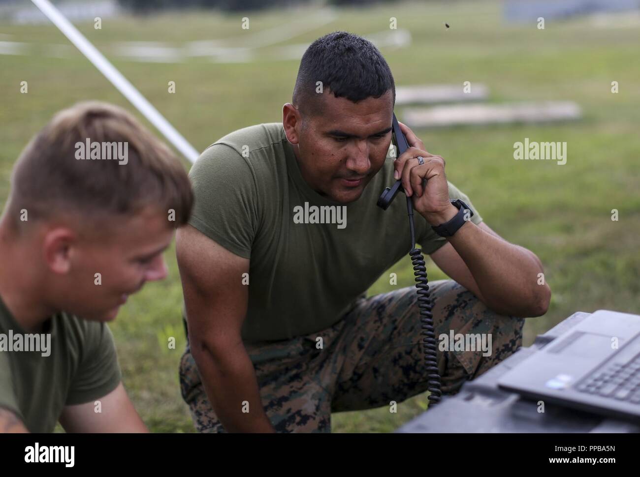 Marines with Marine Aircraft Group (MAG) 13 communicate with Marines at Marine Corps Air Station Miramar utilizing high frequency communication equipment during Exercise Northern Lightning at Volk Field Counterland Training Center, Camp Douglas, Wis. Aug. 16. Exercise Northern Lightning 2018 allows the Air Force, Marine Corps and Navy to strengthen interoperability between services and gives the different branches a greater understanding of aviation capabilities within a joint fighting force. Stock Photo