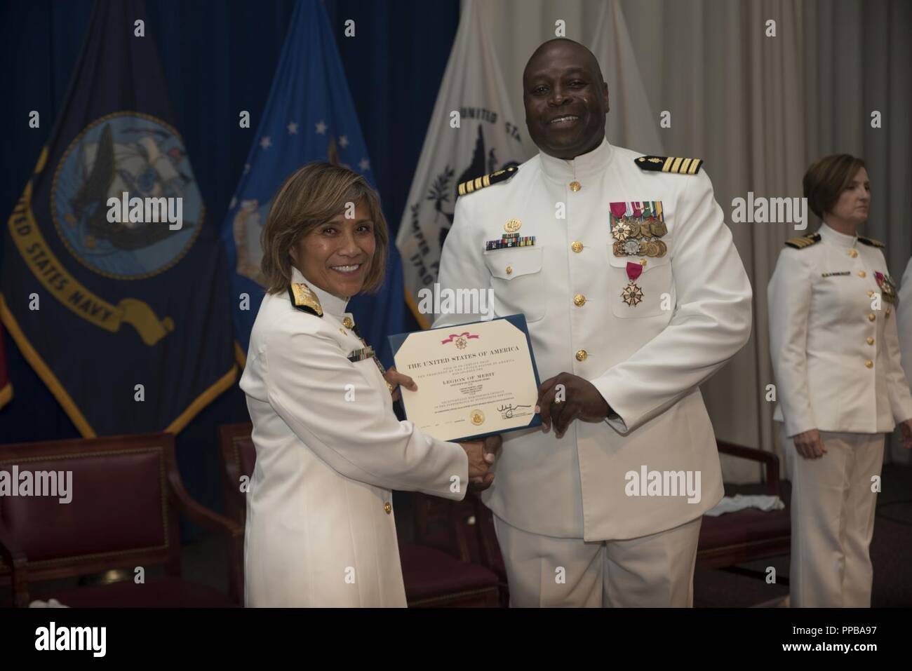 Vice Adm. Raquel C. Bono, Director Defense Health Agency, presents Capt