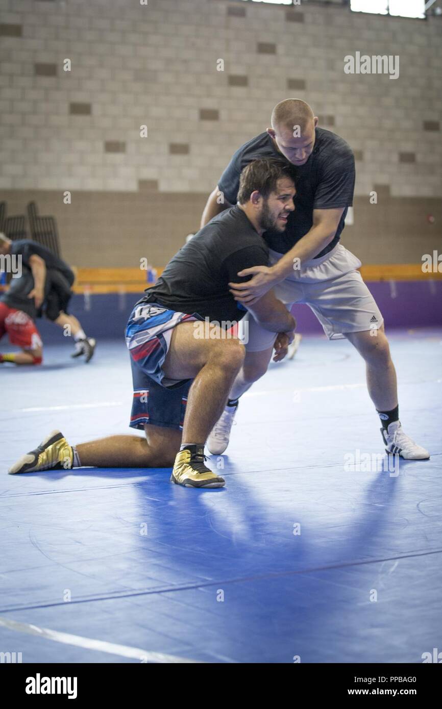 Nick Gwiazdowski, wrestler, USA Wrestling Men’s Freestyle World Team, left, practices a technique with Jake Varner, wrestler, USA Wrestling Men’s Freestyle World Team, at the 43 Fitness Center at Marine Corps Base Camp Pendleton, California, Aug. 20, 2018. The team was practicing in preparation for the 2018 World Wrestling Championships at Budapest this October. Stock Photo