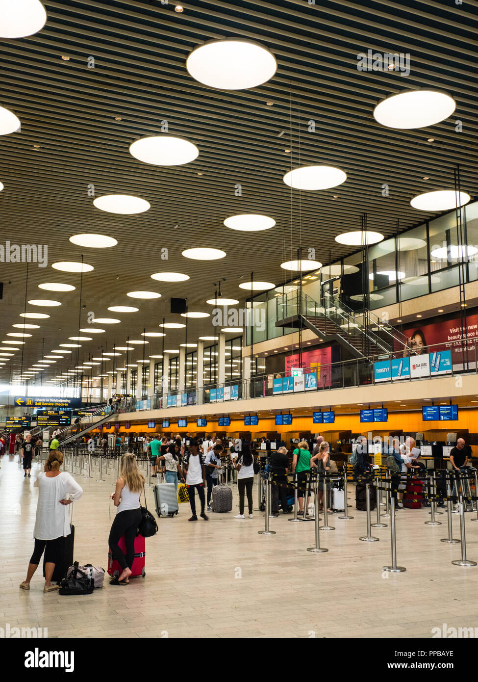 Two Woman Waiting at Luggage Checkin, Copenhagen Airport, Copenhagen