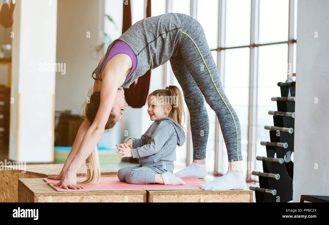 Mom and daughter together perform different exercises Stock Photo Alamy