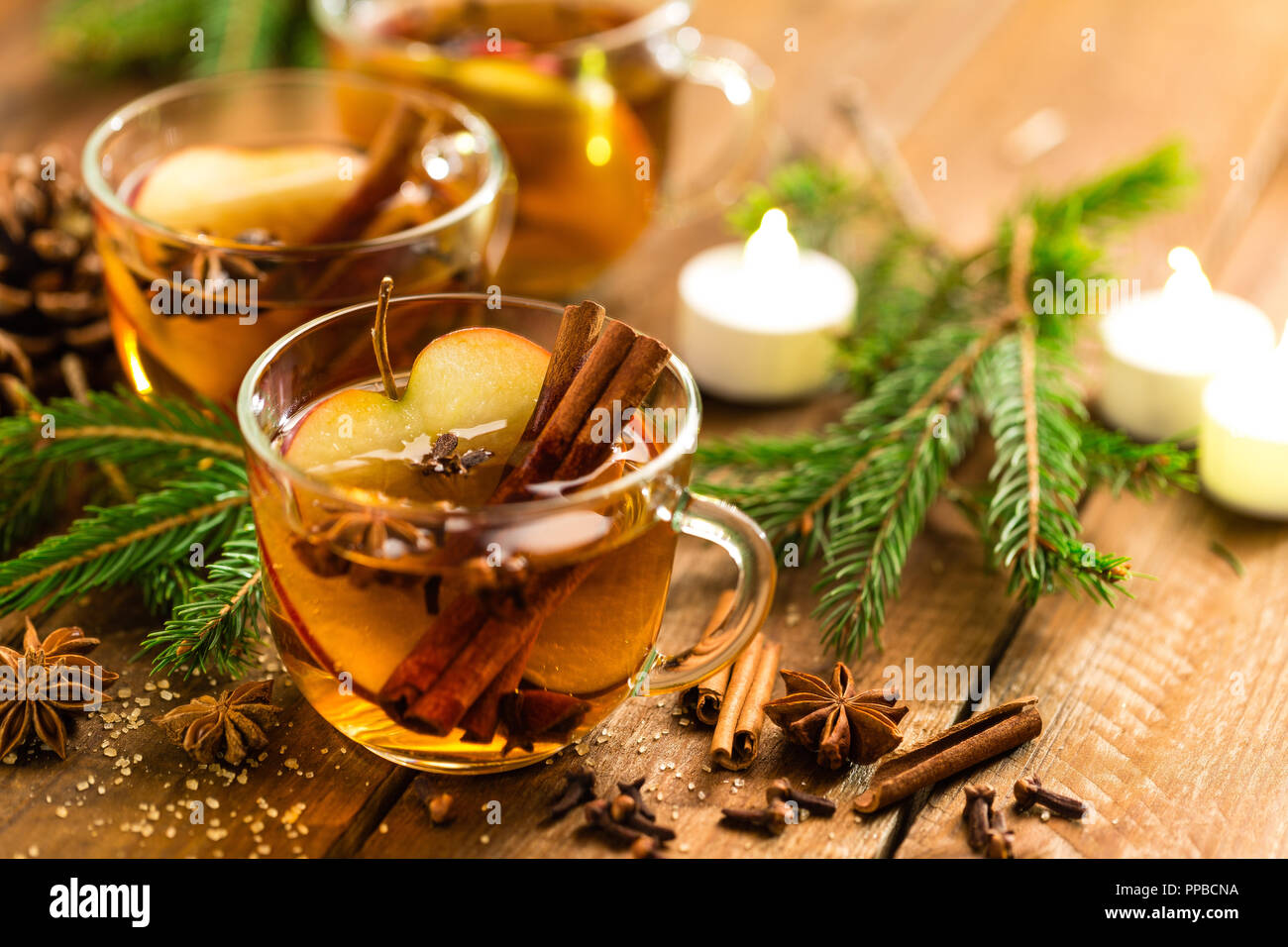 Mulled cider with cinnamon, cloves and anise. Traditional Christmas drink Stock Photo
