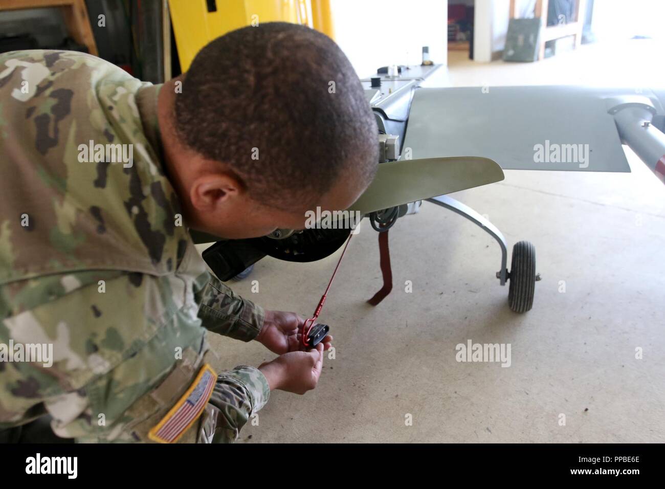 Sgt. Booker, a native of Thomasville, Georgia and assigned to the Unmanned Aircraft Systems platoon, D Company, 6th Brigade Engineer Battalion,, 4th Infantry Brigade Combat Team (Airborne), 25th Infantry Division, U.S. Army Alaska, conducts maintenance on an RQ-7 shadow Aug. 22 at Joint Base Elmendorf-Richardson, Alaska. Stock Photo