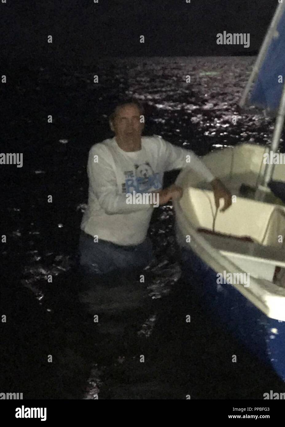 Robert Vonnegut stands in the water next to his 10-foot sailing vessel. The Coast Guard began searching for Vonnegut near Tavernier, Florida Monday, Aug. 27, 2018. Stock Photo