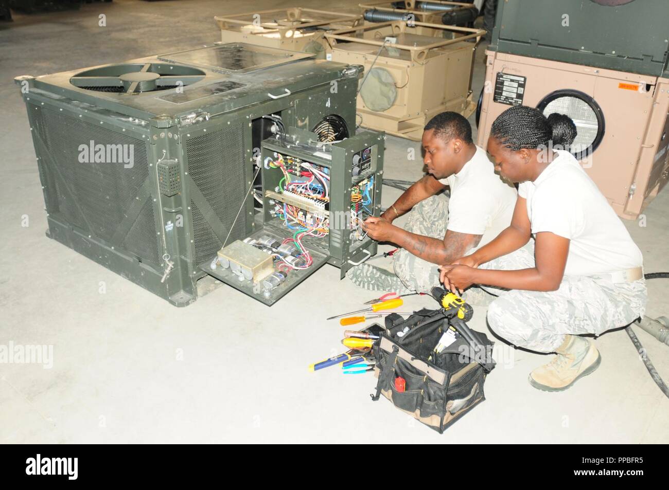 Tech. Sgt. Akil McFarlande, a heating, ventilation, air  condition/refrigeration shop technician and noncommissioned officer in  charge, and airman first class Benjamin St. Brice Jr., a HVAC technician  from the 285th Civil Engineer