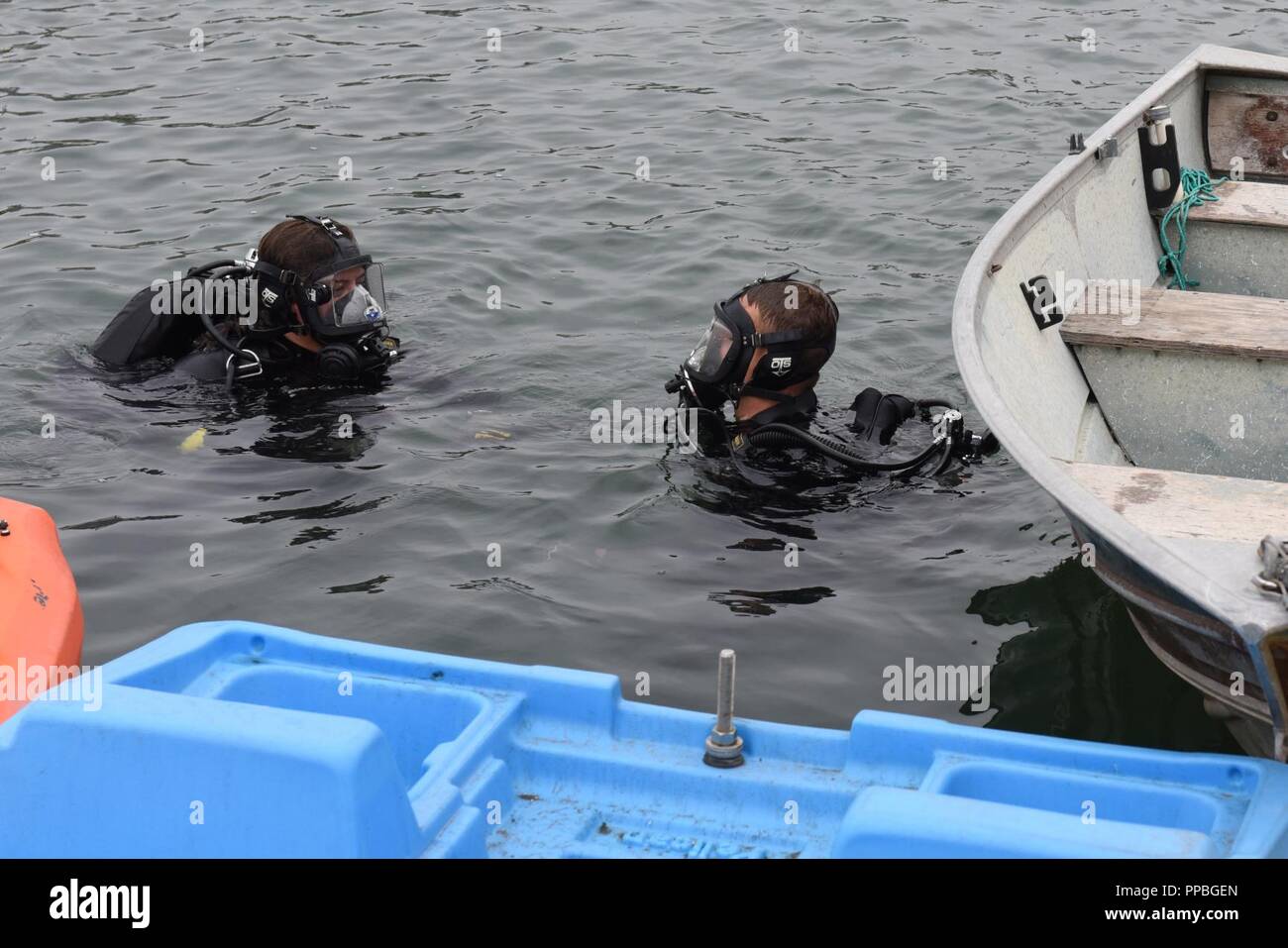 Petty Officer 2nd Class Monique Gilbreath and Petty Officer 2nd Class Brian Lehuede, divers from the Coast Guard Regional Dive Locker West, Maritime Security Response Team West, prepare to search for debris in the San Diego Bay Aug. 25, 2018. The dive team was participating in Operation Clean Sweep 2018, a community cleanup effort along the San Diego Bay. Stock Photo