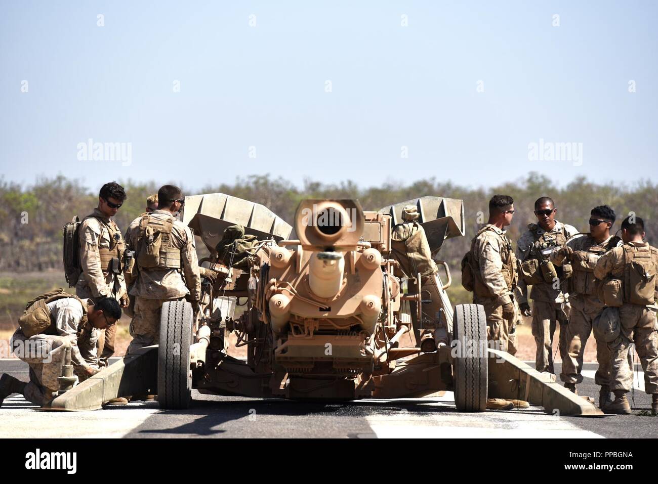 Marines with Mike Battery, 3rd Battalion, 11th Marine Regiment, prepare their M777 Howitzer for aerial lift by an MV-22 Osprey with Marine Medium Tiltrotor Squadron 268 (VMM-268) during Marine Rotational Force – Darwin’s Exercise Koolendong at Mount Bundey Training Area, Australia, Aug. 25, 2018. This is the first time an Osprey has lifted and moved a Howitzer in the field in Australia and it is the first time an entire artillery battery deployed in support of MRF-D. Stock Photo
